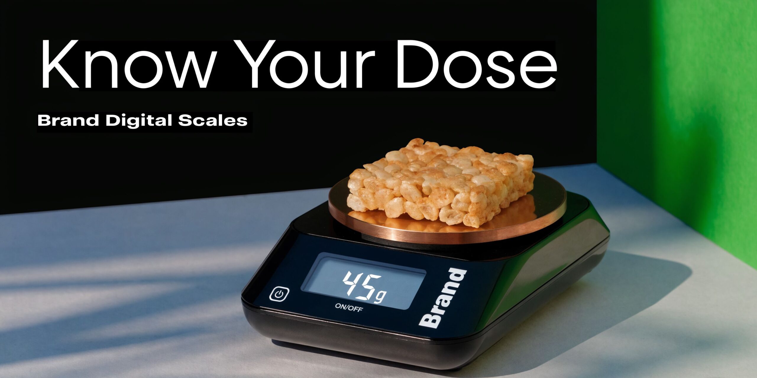 A black digital kitchen scale displays a weight of 45 grams with a rice crispy treat on top.