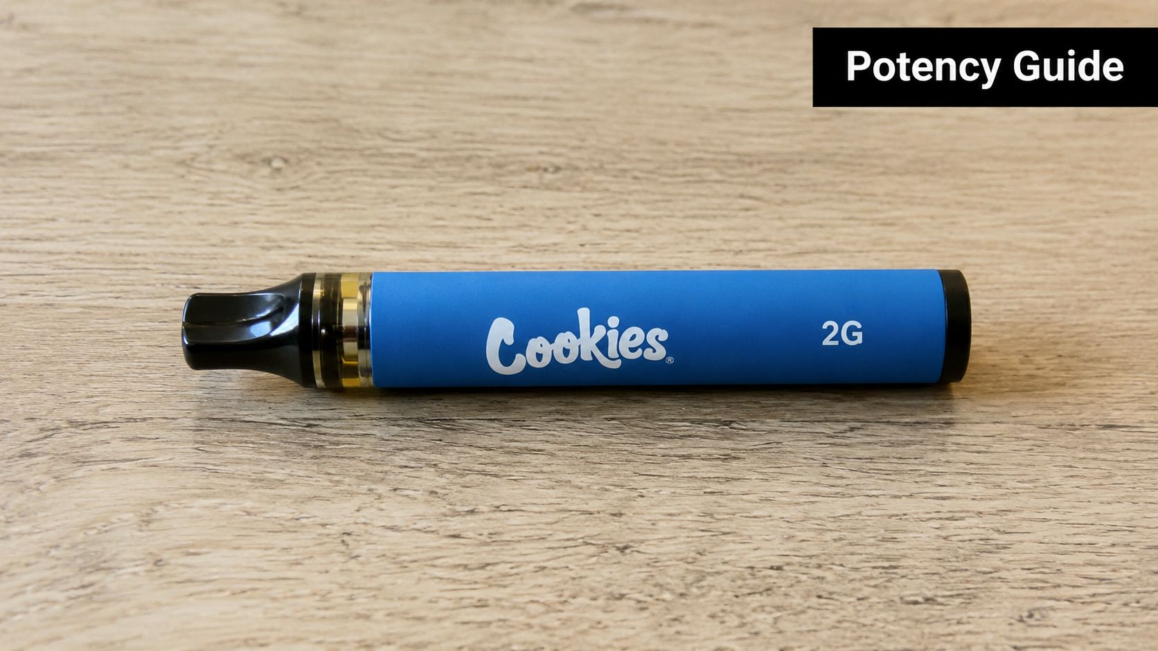 A blue Cookies brand 2 gram cannabis vape disposable pen resting on a light wood surface.
